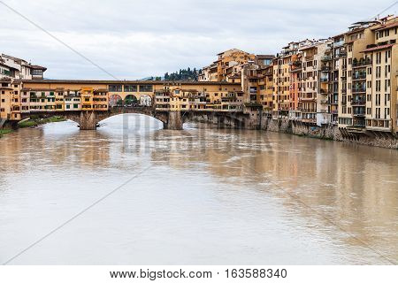 Ponte Vecchio Over Arno River And Houses In Autumn