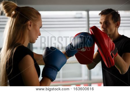 Young competitors trains in boxing in gym