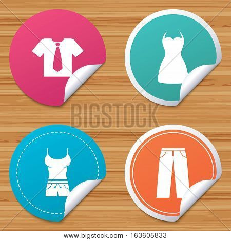 Round stickers or website banners. Clothes icons. T-shirt with business tie and pants signs. Women dress symbol. Circle badges with bended corner. Vector