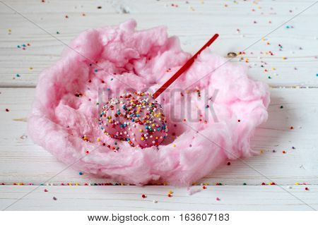 Heart cakepops in the nest made from candy-floss, white background