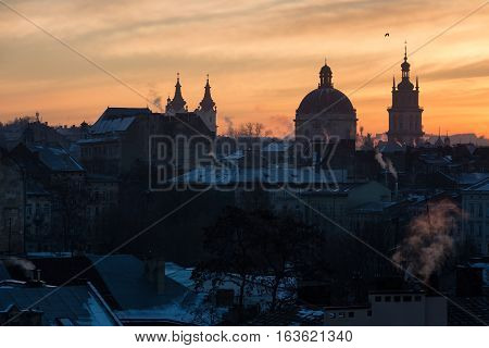 Morning Lviv sunrise. View of the central part of the city and churches: St. Michael's Ukrainian Catholic Church Church of the Holy Communion Korniakt Tower.