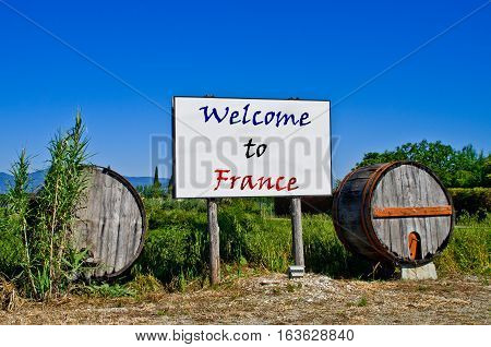 Billboard road surrounded by two wine barrels to welcome the tourists who come to visit France