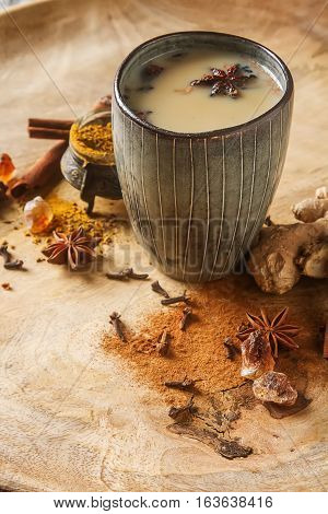 Traditional Indian Masala Tea In Ceramic Cup With Spices To Milk