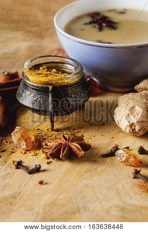 Traditional Indian Masala Tea In Ceramic Cup With Spices To Milk