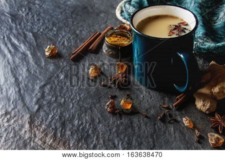 Traditional Indian Masala Tea In Ceramic Cup With Spices To Milk