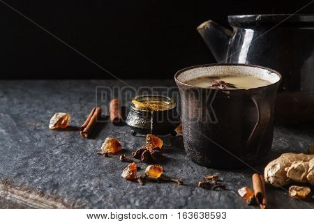 Traditional Indian Masala Tea In Ceramic Cup With Spices To Milk
