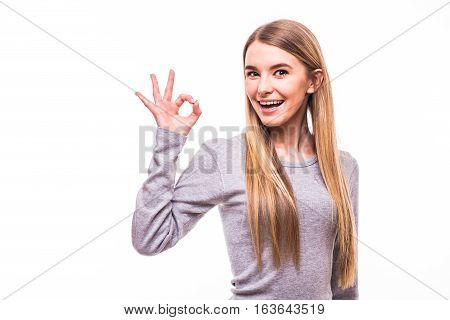 Young Blonde Girl With Okay Gesture On White Background