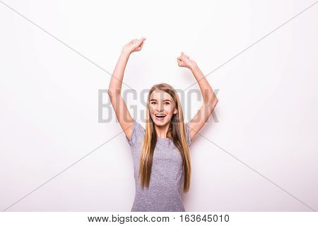 Happy girl with rised hands for victory gesture