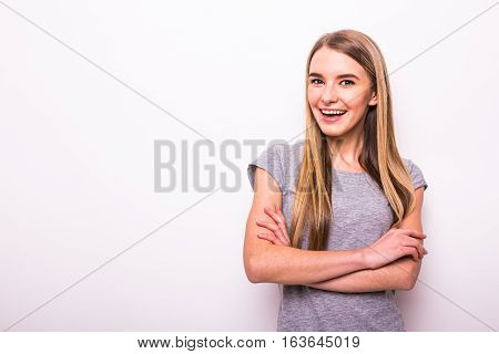 Happy Blonde Girl With Crossed Hands On White