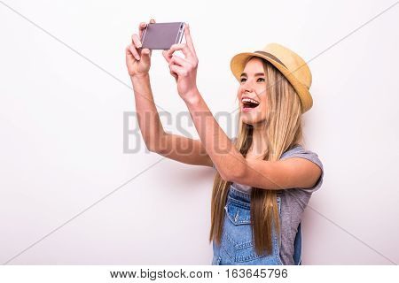 Cheerful Girl In Cap Making Selfie On Smartphone