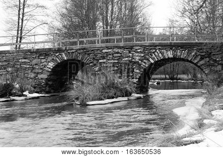 old stonebridge over the cold water one grey day in early spring