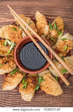 Homemade asian сhicken potstickers with soy sauce.