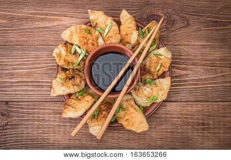 Homemade asian сhicken potstickers with soy sauce.