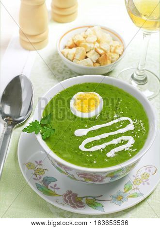 Cream soup with egg sour cream and wine on the table studio shot