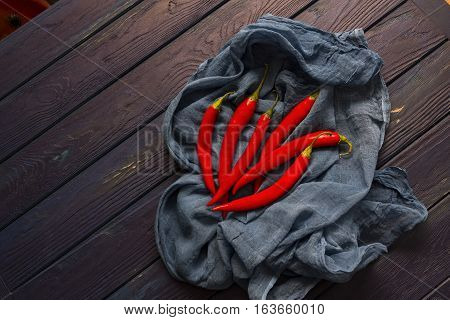 red chili pepper on the wood blue table with the shawl