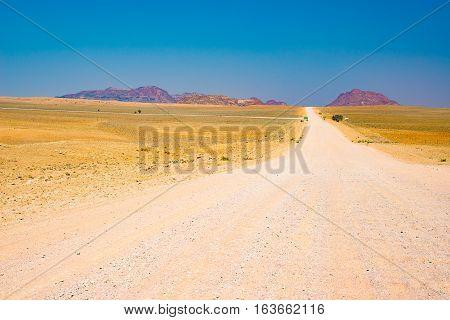 Gravel 4X4 Road Crossing The Colorful Desert At Twyfelfontein, In The Majestic Damaraland Brandberg,