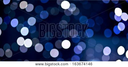 Christmas background. Festive abstract holidaysbackground with bokeh defocused lights and stars, blue color, toned