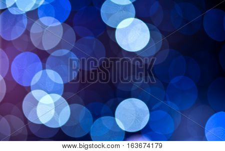 Christmas background. Festive abstract holidaysbackground with bokeh defocused lights and stars, blue color, toned