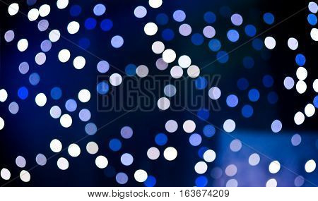 Christmas background. Festive abstract holidaysbackground with bokeh defocused lights and stars, blue color, toned