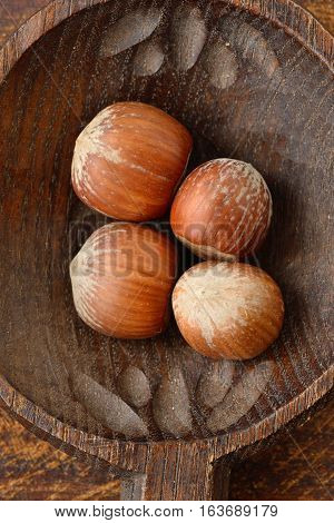 Group of hazlenuts on a wooden spoon