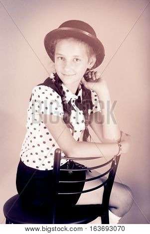 Beautiful young girl in black hat on his head. Black and white image