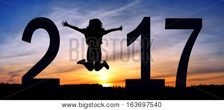 Silhouette young woman jumping on the sea and 2016 years while celebrating new EAP, 2016, happy girl. silhouette of girl at sunset, jumping on the background of sunset