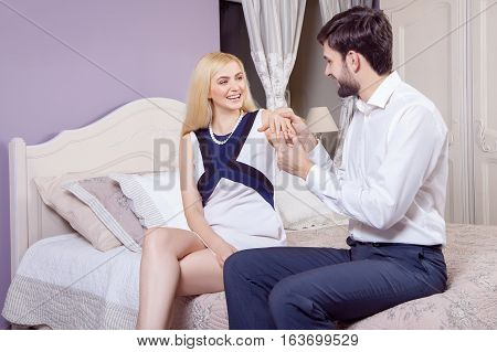 Handsome man doing a marriage proposal while offering his wife an engagement ring. Boyfriend make a marriage proposal to his girlfriend in valentine days.