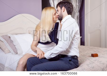 Handsome man doing a marriage proposal while offering his wife an engagement ring. Boyfriend make a marriage proposal to his girlfriend in valentine days.