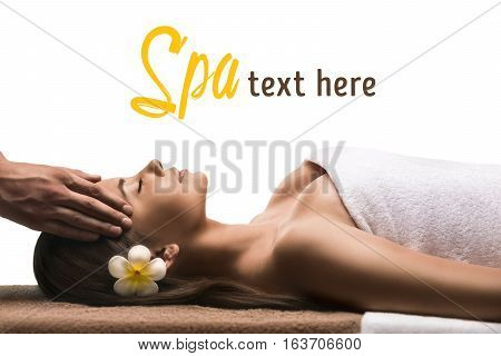 Beautiful young girl has a facial massage. Luxury spa treatment. Isolated on white
