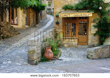Beynac-et-Cazenac France - August 25 2015: Typical French townscape with a gourmet store front and cobblestone streets in the traditional town Beynac-et-Cazenac along Dordogne river in Perigord region France.
