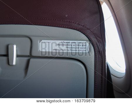 BUDAPEST HUNGARY - CIRCA SEPTEMBER 2016: WizzAir aicraft seat with multilingual tags (English Hungarian Ukrainian)