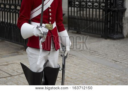 Guard of the royal british army stands with sword in hand. selective focus shallow depth of field