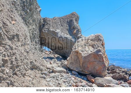 seaside covered by big rocks after landslip