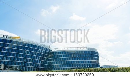 STUTTGART GERMANY - MAR 26 2016: Ernst & Young audit tax firm logotype on building facade seen from the german Autobahn near Stuttgart. EY is one of the largest professional services firm in the world and is one of the 
