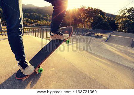 one young skateboarder legs skateboarding at skatepark