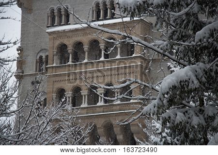 Fussen Germany - December 26 2014: view of the fragment of Neuschwanstein Castle between tress in winter time on December 26 2014 near Fussen Germany.