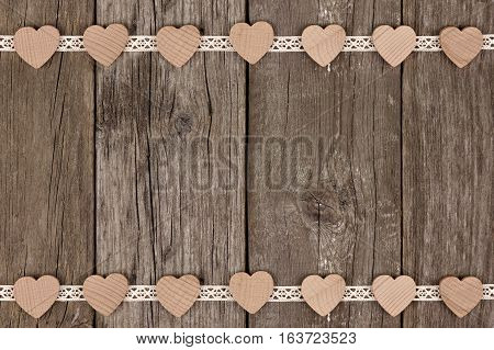 Double Border Of Wooden Hearts And Ribbon Lace Over A Rustic Wooden Background