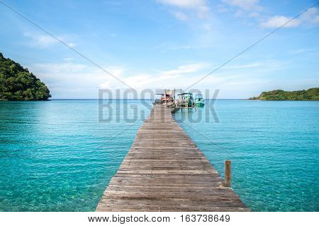 Clear sky and fisher boat habor with wooden bridge