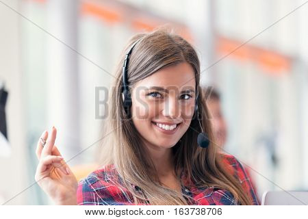 Close up plan of a smiling businesswoman in a call centre.
