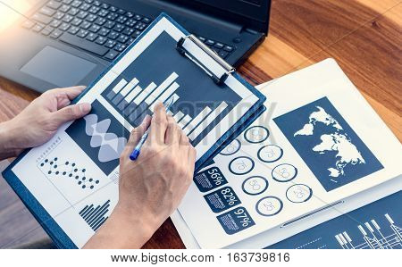 Business Workers Discussing Digital Graphs And Diagrams Indicating Progres