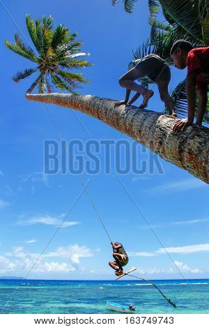 Lavena, Fiji - November 27: Unidentified Kids Swing On A Rope Swing On November 27, 2013 In Lavena V