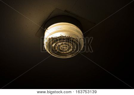 Single garage light glowing in the dark