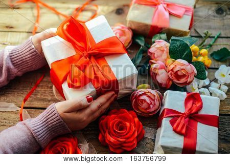 Valentine's Day Concept. Gift With Red Bow  On The Wooden Backg