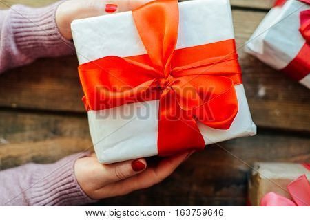 Valentine's Day Concept. Gift With Red Bow  On The Wooden Backg