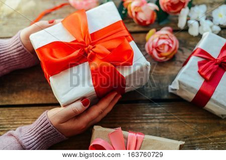 Valentine's Day Concept. Gift With Red Bow  On The Wooden Backg