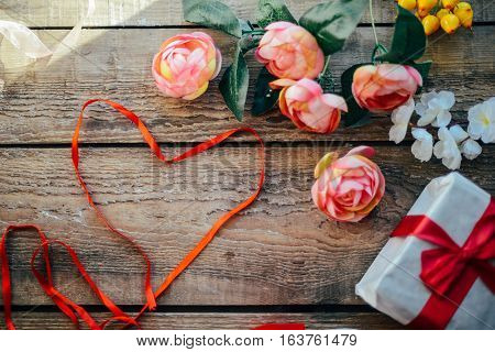 Valentine's Day Concept. Gift With Red Bow  On The Wooden Backg