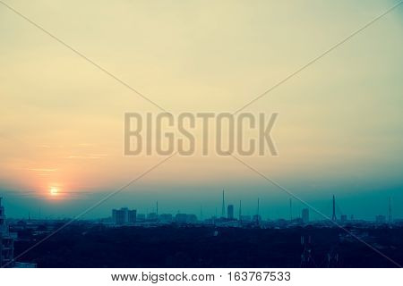 In large cities the evening sky the sun sets shine.