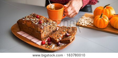 Sliced Home-made Loaf Of Pumpkin Bread, Woman's Hands And Tea
