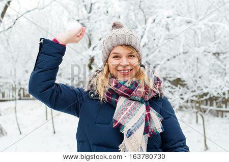 Picture of a pretty girl holding a snowball