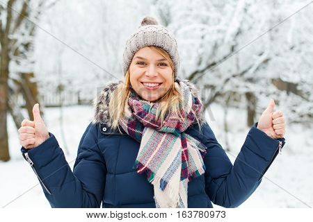 Picture of a happy beautiful girl showing thumbs up